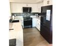 Modern kitchen with stainless steel appliances, white cabinets, and black accents at 4083 Nook Way # A, Las Vegas, NV 89103