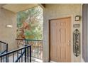 Inviting front entrance with a welcome sign, exterior lighting, and a view of lush greenery at 4400 S Jones Blvd # 2103, Las Vegas, NV 89103