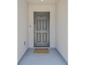 A welcoming entryway with a stylish door and a cheerful doormat at 442 Bridal Veil Falls St, Indian Springs, NV 89018