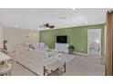Bright and airy living room with tile flooring, ceiling fan, and backyard views at 442 Bridal Veil Falls St, Indian Springs, NV 89018