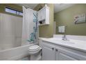 Well-lit bathroom featuring a shower-tub combo and a white vanity with storage at 4804 Portola Vista Ave, Las Vegas, NV 89139