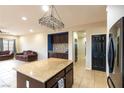 Open kitchen featuring a central island, stainless steel fridge, and adjacent living area at 6636 Brent Scott St, North Las Vegas, NV 89086