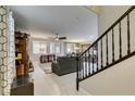 Bright and open living room with tile floors, large windows, and a staircase leading to the upper level at 7553 Old Compton St, Las Vegas, NV 89166