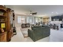 Open living area with modern furniture, a ceiling fan, and a view into the dining area and kitchen at 7553 Old Compton St, Las Vegas, NV 89166