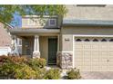 Close-up of house highlighting the stone accents, tidy front yard, and covered porch at 7598 Alexander Hills St, Las Vegas, NV 89139