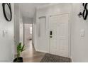Bright entryway with wood floors, neutral walls, and modern decor accents at 7628 Picnic St, Las Vegas, NV 89131