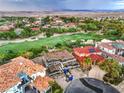 Expansive aerial view showcases the golf course community and nearby mountains at 8 Rue Du Ville Way, Henderson, NV 89011