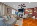 Inviting living room with hardwood floors, comfortable seating, fireplace and a ceiling fan at 8600 W Charleston Blvd # 2078, Las Vegas, NV 89117