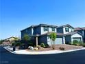 Two-story home with a two-car garage, landscaped front yard, and gated entry at 8694 Glen Echo Ave, Las Vegas, NV 89148