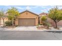 Charming single-story home featuring a two-car garage and well-maintained desert landscaping in front at 8942 Partridge Hill St, Las Vegas, NV 89148