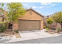Charming single-story home featuring a two-car garage and well-maintained desert landscaping in front at 8942 Partridge Hill St, Las Vegas, NV 89148