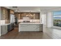 Gourmet kitchen with stone countertops, stainless steel appliances, custom cabinetry, and an adjacent dining area at 9101 Alta Dr # 207, Las Vegas, NV 89145