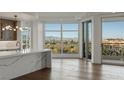 Modern kitchen adjacent to an open room with floor to ceiling windows offering panoramic city and mountain views at 9101 Alta Dr # 207, Las Vegas, NV 89145
