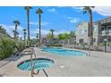 Community pools and palm trees create a vacation feel at 9470 Peace Way # 233, Las Vegas, NV 89147
