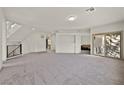 Expansive, light-filled living area with neutral carpet, ideal for entertaining and relaxation, and access to outdoor space at 9830 Wild Coyote Ct, Las Vegas, NV 89141