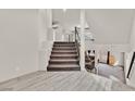 Bright and airy staircase with modern railings and a landing overlooking a spacious living area, perfect for a contemporary home design at 9830 Wild Coyote Ct, Las Vegas, NV 89141