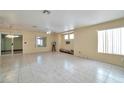 Spacious living room with tile flooring, and sliding glass door access at 9614 Orchard Oasis Ct, Las Vegas, NV 89147