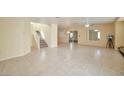Expansive living area with tile flooring and stairway leading to the upper level at 9614 Orchard Oasis Ct, Las Vegas, NV 89147