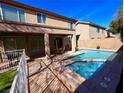 Spacious backyard with a sparkling pool, a covered patio, and plenty of room for entertaining and relaxing at 1011 Pecos River Ave, Henderson, NV 89002