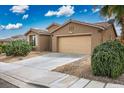 Well-maintained home with a two-car garage and beautiful desert landscaping under a sunny sky at 10513 Shanna Trellis Ave, Las Vegas, NV 89144