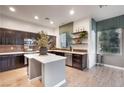 Modern kitchen features dark cabinets, stainless steel appliances, and a center island at 11334 Colinward Ave, Las Vegas, NV 89135
