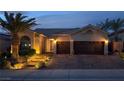 Well-lit front exterior features a multi-car garage, desert landscaping and brick paved driveway at 1342 Calle Calma, Henderson, NV 89012