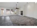 Spacious living room with fireplace, tile and carpet flooring and access to backyard at 1342 Calle Calma, Henderson, NV 89012