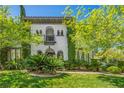 Charming two-story stucco home with meticulously manicured lawn and lush landscaping creates curb appeal at 1409 Chambolle Ct, Las Vegas, NV 89144