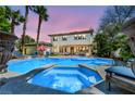 Resort-style backyard with a sparkling pool, hot tub, and covered patio, perfect for outdoor entertaining at 1409 Chambolle Ct, Las Vegas, NV 89144