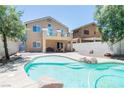 Expansive backyard features a refreshing pool with rock accents and a covered patio at 1922 Pyle, Las Vegas, NV 89183