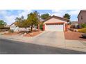 Lovely home featuring a two-car garage, landscaped yard with desert plants and a concrete driveway at 208 Lynbrook St, Henderson, NV 89012