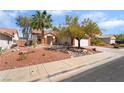 Charming home with a two-car garage, desert landscaping, and a tidy front yard at 208 Lynbrook St, Henderson, NV 89012