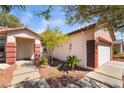 Inviting home with a two-car garage and a walkway leading to the front door at 208 Lynbrook St, Henderson, NV 89012