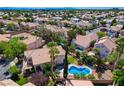 Expansive aerial view showcases a neighborhood with lush greenery, pools, and well-maintained homes at 2401 Rice Flower Cir, Las Vegas, NV 89134