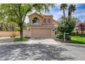 Inviting two-story home featuring a spacious two-car garage, manicured landscaping, and neutral exterior at 2401 Rice Flower Cir, Las Vegas, NV 89134