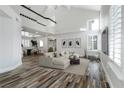 A bright, airy living room featuring high ceilings, modern decor, and ample natural light from large windows at 2401 Rice Flower Cir, Las Vegas, NV 89134