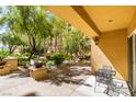 Charming patio features mature landscaping and comfortable seating area at 2405 W Serene Ave # 236, Las Vegas, NV 89123
