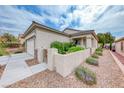 Single story home featuring desert landscaping with a stone accentuated driveway and gated courtyard at 2561 Cosmic Dust St, Henderson, NV 89044