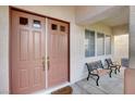 Welcoming front porch with double doors and comfortable seating, creating a warm entrance to the home at 2727 Warm Rays Ave, Henderson, NV 89052