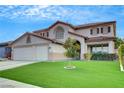 Beautiful two-story home featuring an expansive green lawn, perfect for outdoor activities and relaxation at 2727 Warm Rays Ave, Henderson, NV 89052