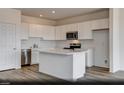 Modern kitchen featuring white cabinets, stainless steel appliances, and a large center island at 3044 Dagny St # Lot 7, Las Vegas, NV 89121