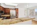 Open-concept kitchen featuring stainless steel refrigerator and a granite countertop at 3225 Casey Dr # 203, Las Vegas, NV 89120