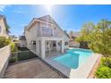 Back exterior with a beautiful swimming pool, complemented by a small deck and balcony above at 3329 Buffalo Narrows Cir, Las Vegas, NV 89129