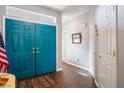 Inviting foyer featuring sleek wood floors and striking blue double doors at 3491 Cottage Thistle Dr, Laughlin, NV 89029