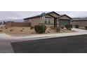 Attractive single-story home featuring desert landscaping and a concrete driveway at 3530 E Moffat Ave, Pahrump, NV 89061