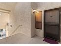 Welcoming condo entrance featuring a secure door, ambient lighting, and stucco walls at 3843 Desert Marina Dr # 232, Laughlin, NV 89029