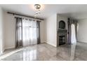 Bright living room features tile floors, modern lighting, fireplace, and light window treatments at 4316 W Lake Mead Blvd # 202, Las Vegas, NV 89108