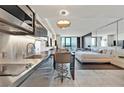 This condo features a modern stainless steel kitchen with a breakfast bar that opens to the living and bedroom at 4381 W Flamingo Rd # 1609, Las Vegas, NV 89103