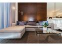 Comfortable sectional sofa with decorative pillows and a glass coffee table in a modern living room at 4381 W Flamingo Rd # 1809, Las Vegas, NV 89103