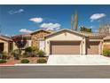 Charming single-story home with stone accents, a well-maintained lawn, and a convenient three-car garage at 5224 E San Palo Dr, Pahrump, NV 89061